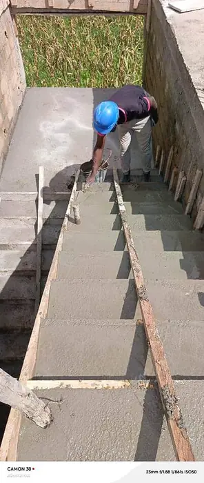 Clifton Group building construction, mason finishing concrete stairs